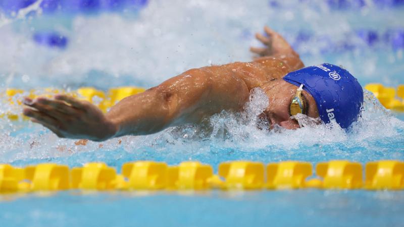 A male swimmer competing in butterfly