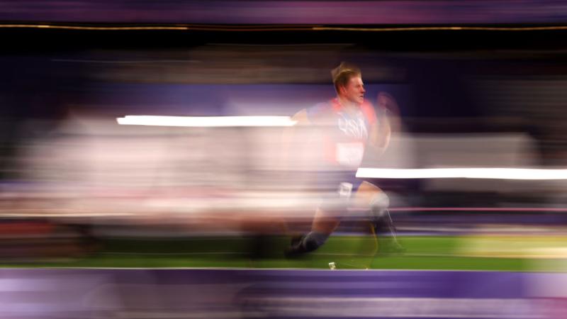 A man with prosthetic legs running in a track