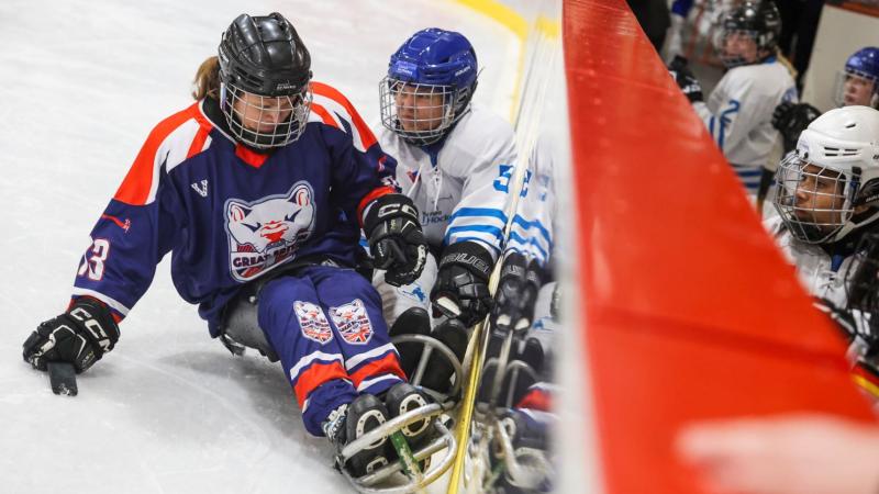 A Team GB and a Team World female player in a Para ice hockey game