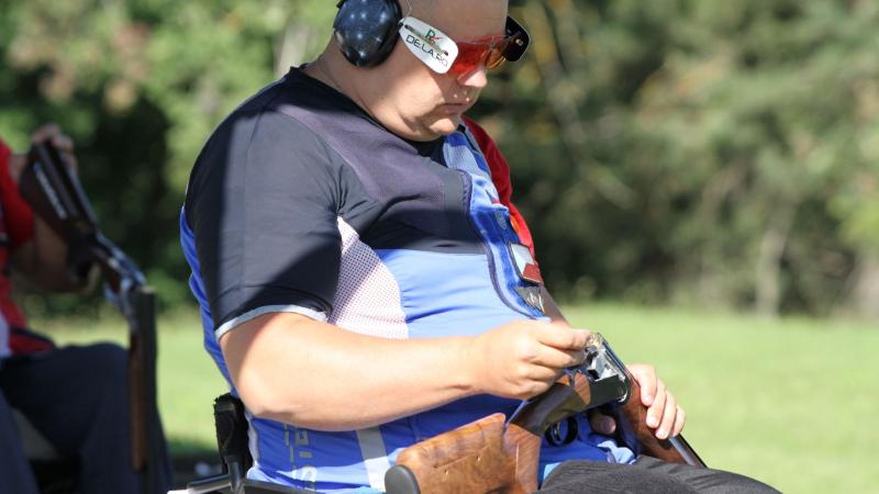 A shooter reloads his cartridge.