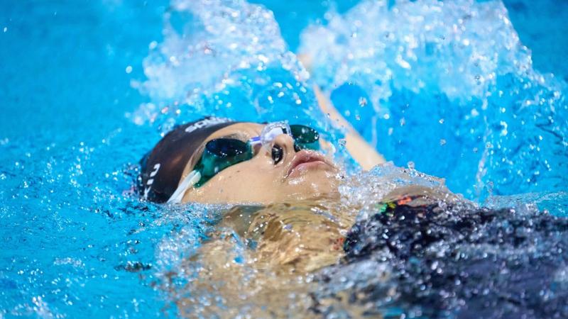 A female Para swimmer in a backstroke event
