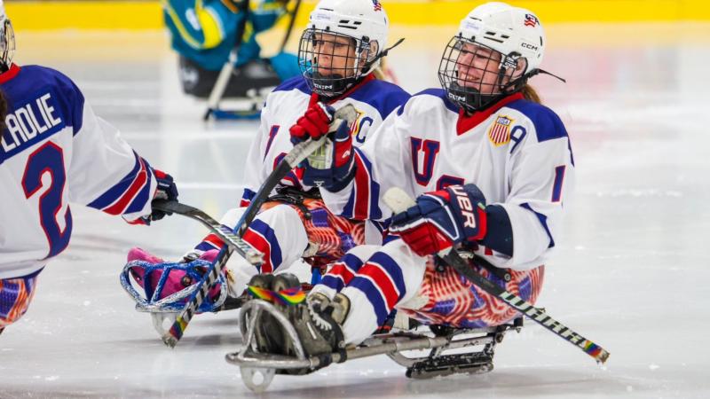 Three USA female Para ice hockey players celebrating
