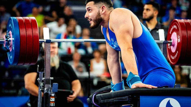 An athlete reacts after his round
