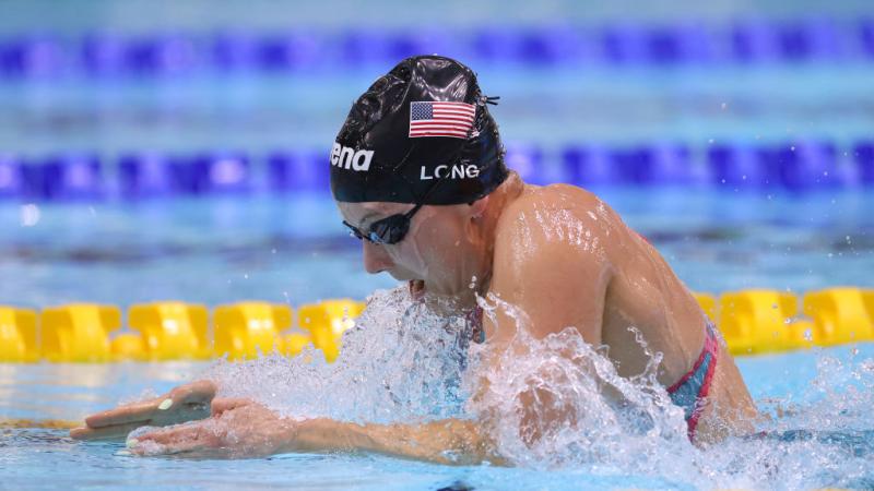 A female Para swimmer competing in breaststroke