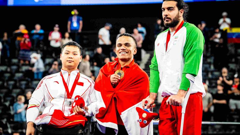 Athletes pose on the podium