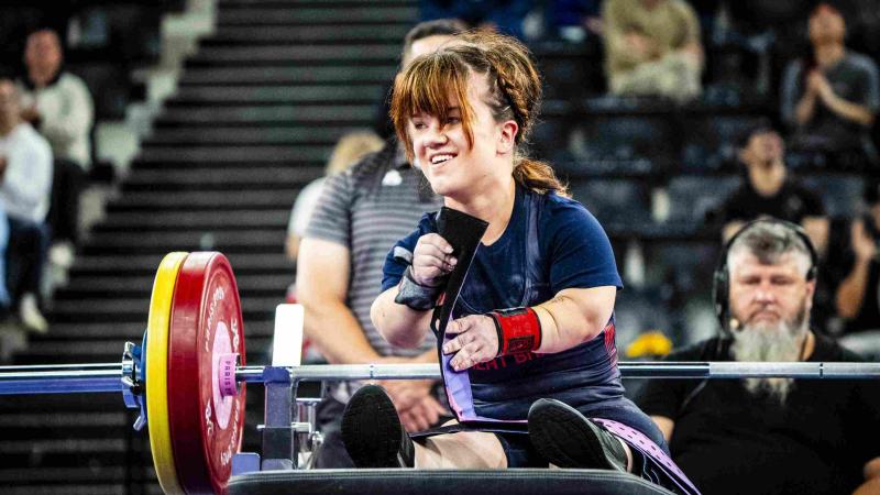 An athlete reacts in joy after a successful lift