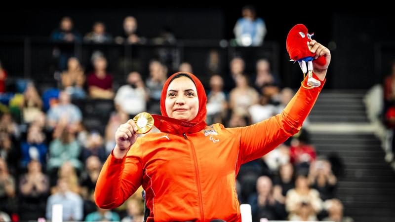 An athlete celebrates on podium