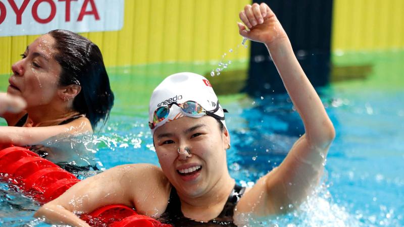 An athlete celebrates her gold medal