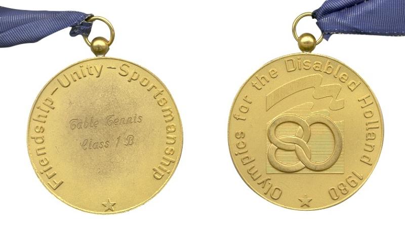 The back and front of the gold medals from the Arnhem 1980 Paralympic games.