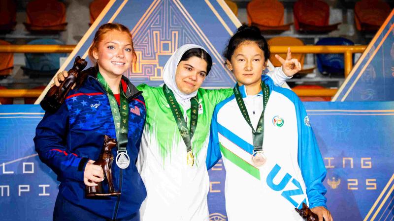 Athletes smile on podium 