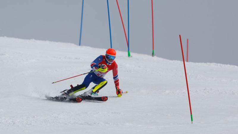 A male Para alpine skiing athlete is competing in the Para sport at the Beijing 2022 Paralympics