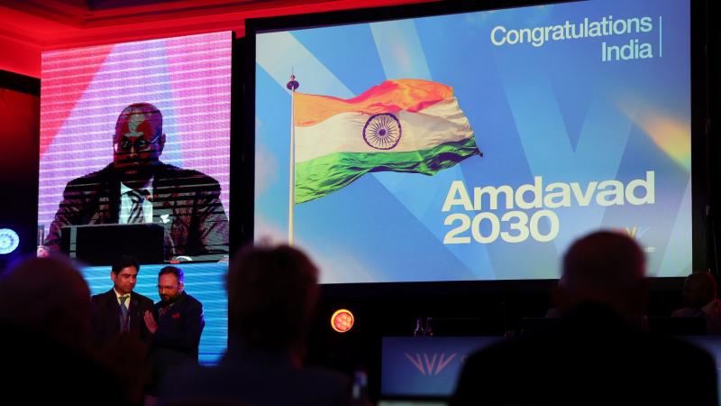 A photo of a screen that says Congratulations to India Amdavad 2030