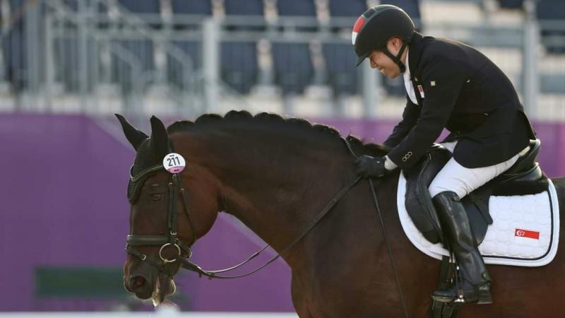 A photo taken from the side of a Para equestrian rider