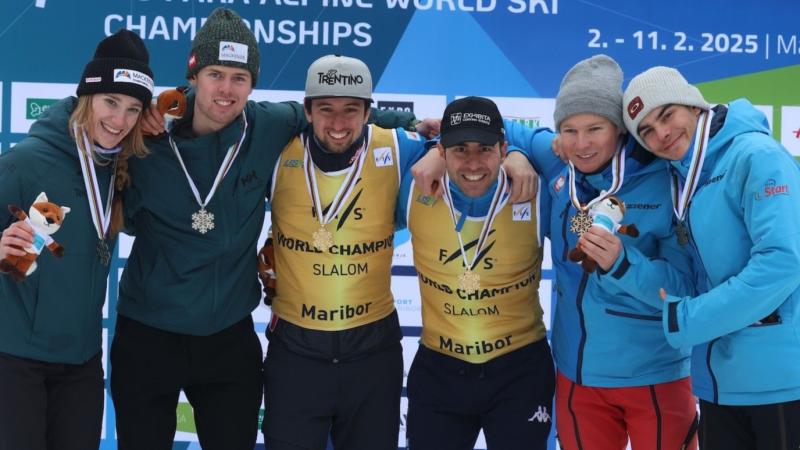 Six Para alpine skiers and guides pose for a photo on the podium