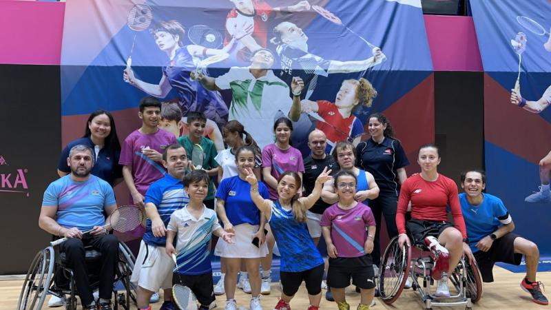 A group of Para badminton players and officials pose for a photo