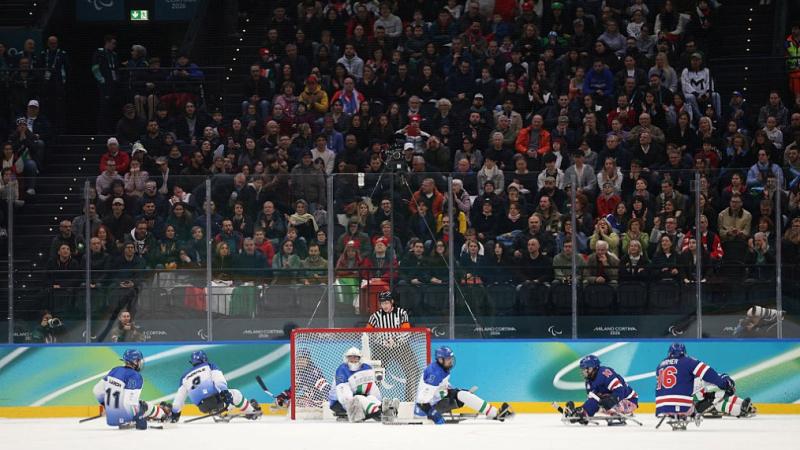 USA and Italy playing Para ice hockey in front a packed stand