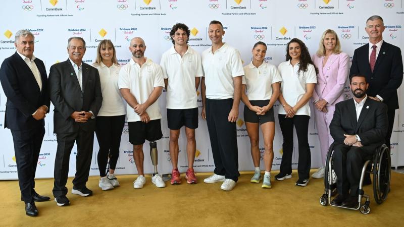 Eleven people stand in a line for a picture