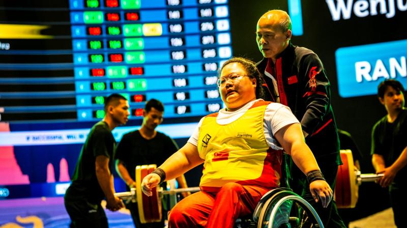 An athlete gestures before attempting a lift