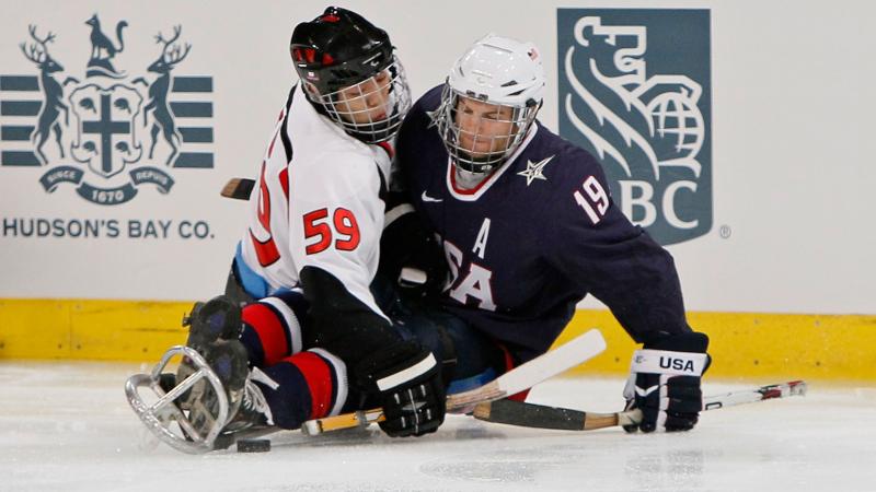 Noritaka Ito and Taylor Chace battling for the puck.