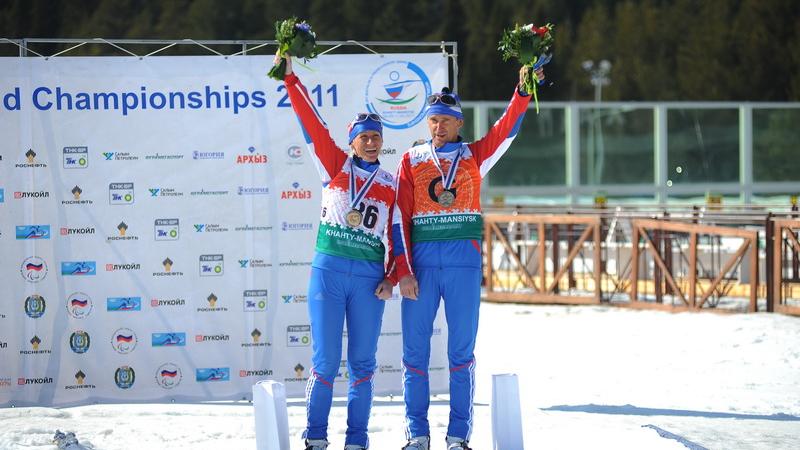 Skier on the podium with her guide