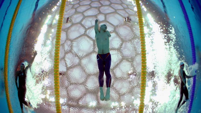 Underwater shot in a swimming pool. A swimmer is photographed from below.
