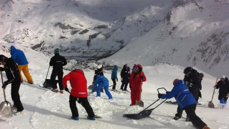 Coaches working hard on the slope to prepare for the race.