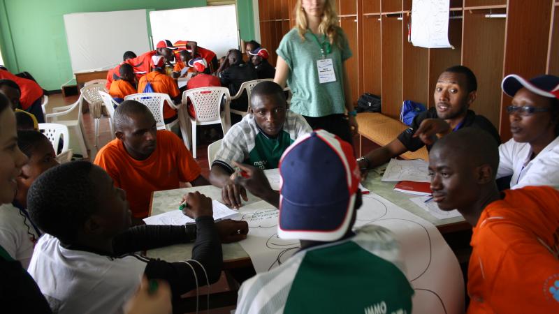 athletes sitting around a table in discussion