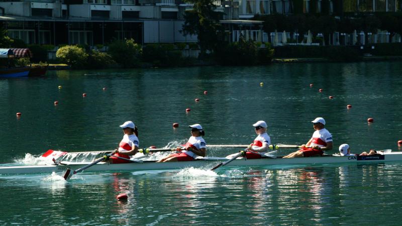 A picture of 4 people rowing