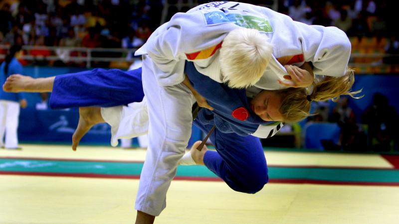 a picture of 2 athletes competing in a judo match