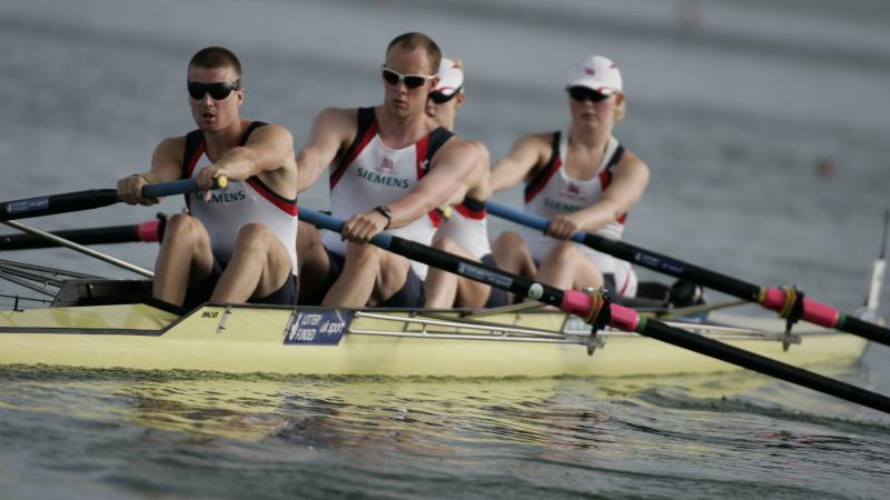 A picture of 4 people rowing