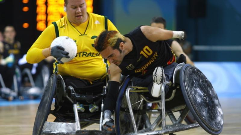 A picture of 2 Wheelchair Rugby players.