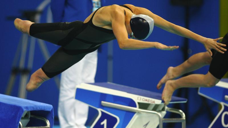 A picture of a girl jumping into a pool