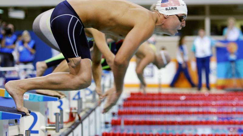 A picture of a man jumping into a pool