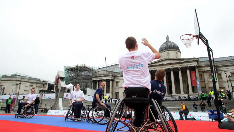 A picture of a man in a wheelchair playing Basketball