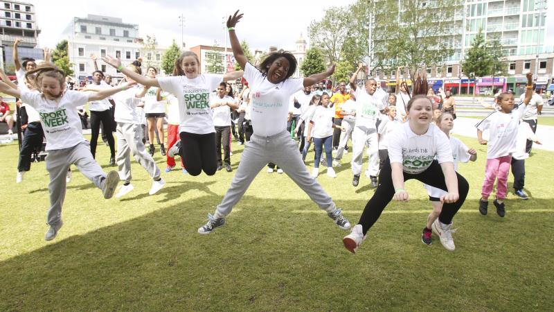 A picture of children jumping in a group picture