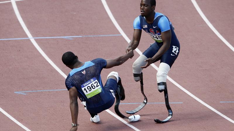 USA's Blake Leeper give teammate Jerome Singleton a helping hand