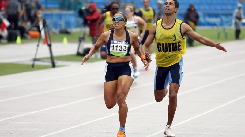 Terezinha Guilhermina running with guide