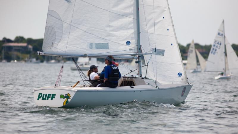 A picture of 3 persons in a boat