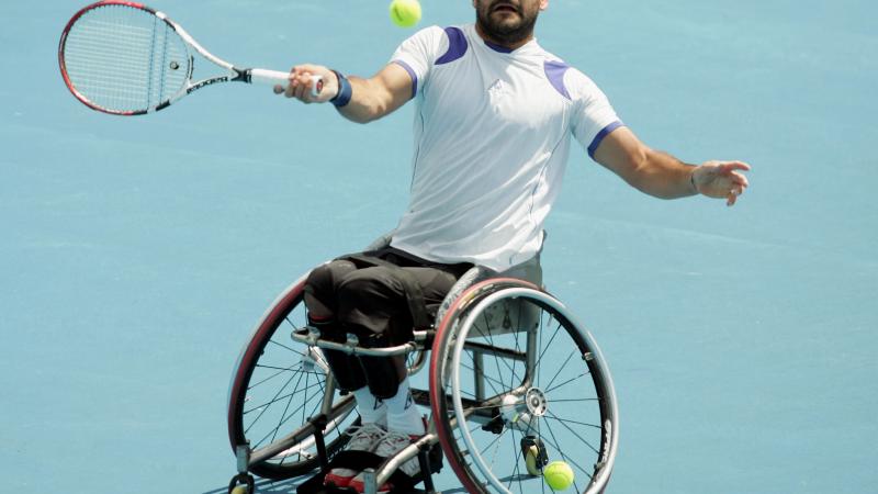 A picture of man in a wheelchair playing tennis
