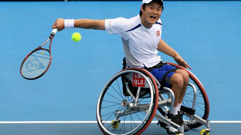 A picture of a man in a wheelchair playing tennis