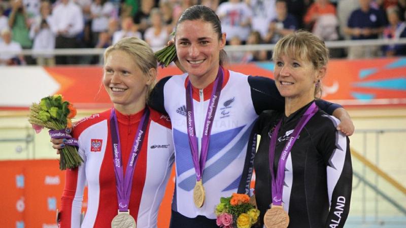 A picture of 3 womens on a podium