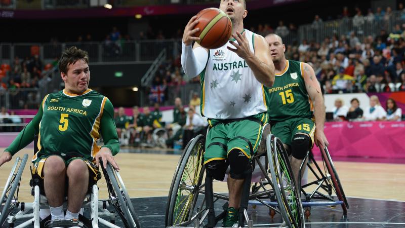 A picture of a man in a wheelchair playing basketball.