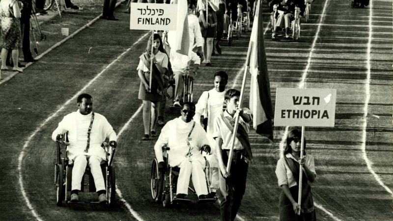 A picture of wheelchair athletes parade