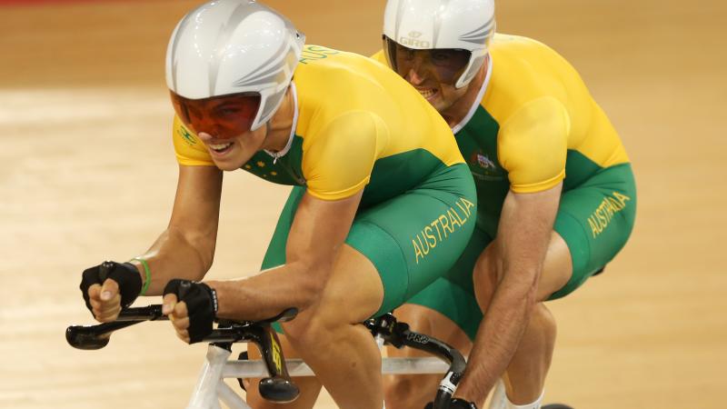 A picture of a two man cycling wit the same bicycle