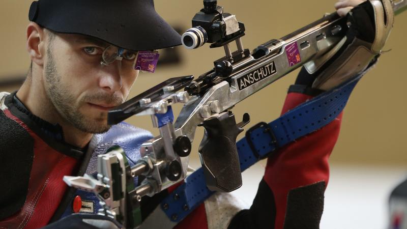 Matthew Skelhon of Great Britain catches a glimpse of the camera while competing in the mixed R6-50m Rifle Prone- SH1 final