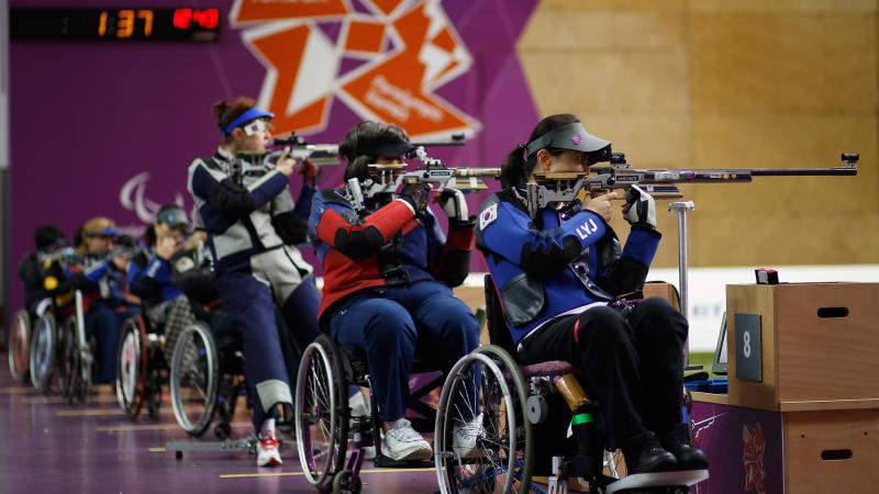 Women shoot under the backdrop of the London 2012 Paralympic games logo during the Women's R8-50m Rifle 3 Positions-SH1 final