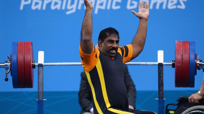 Mariappan Perumal of Malaysia waves to the crowd before he competes.