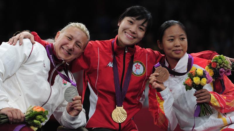 A picture of three women showing their medals