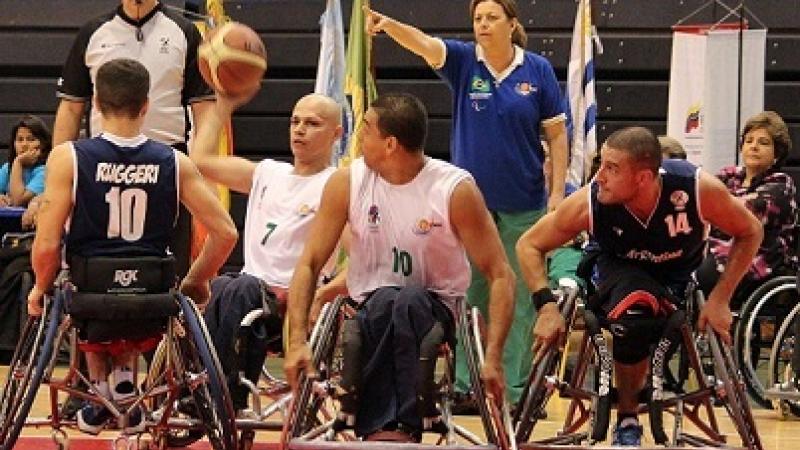 A picture of men in wheelchair playing basketball