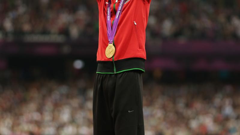 Abraham Tarbei A picture of a man celebrating his victory on a podium